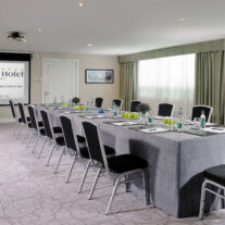 Elegant hotel conference room set for a business meeting.