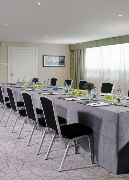 Elegant hotel conference room set for a business meeting.