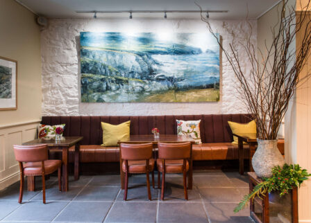 Cosy hotel lounge with art, plush seating.