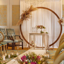 Elegant indoor wedding setup with flowers and candles in a warm, inviting ambience.