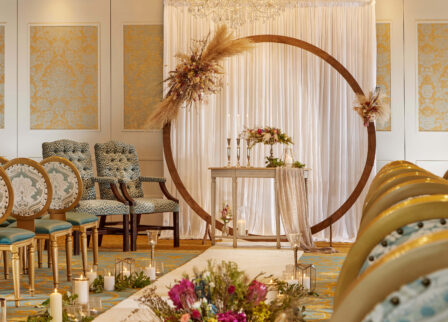 Elegant indoor wedding setup with flowers and candles in a warm, inviting ambience.